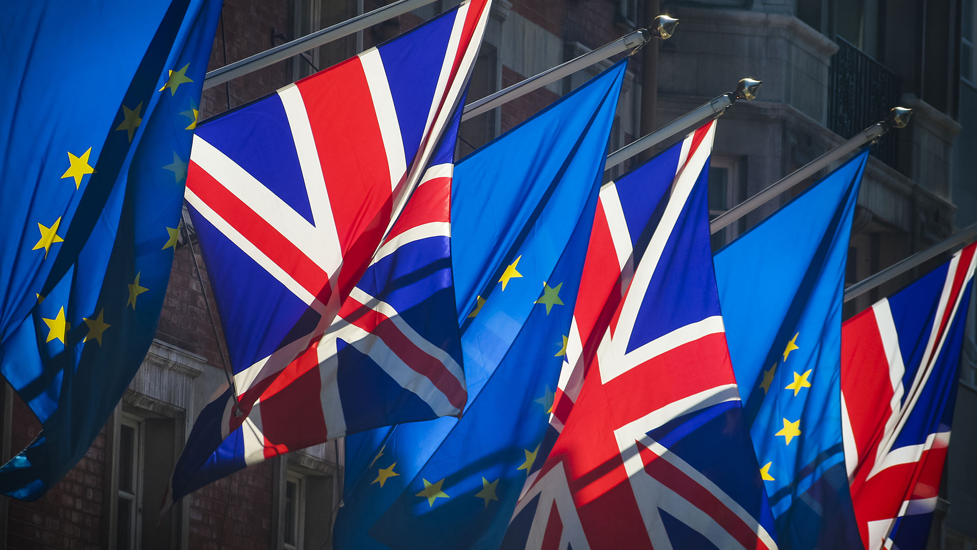 European Union and United Kingdom flags together on sunny day