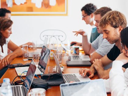 Team sharing desk to work